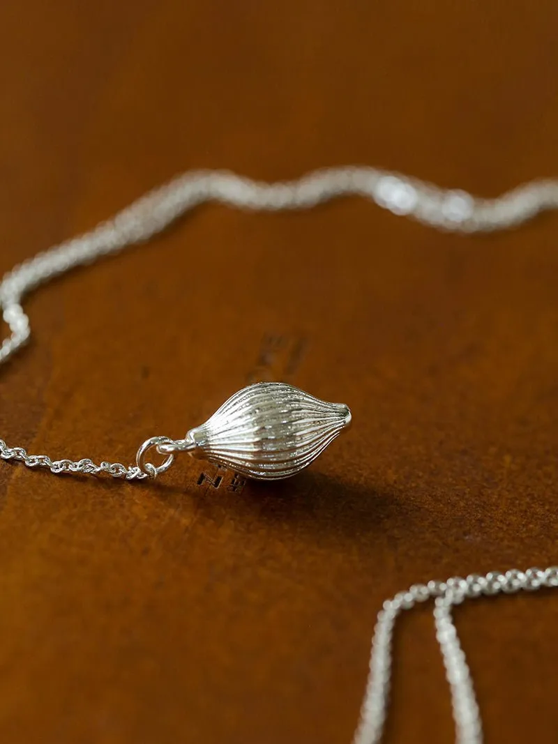 Long Gold and Silver Textured Seed Pendant Necklace